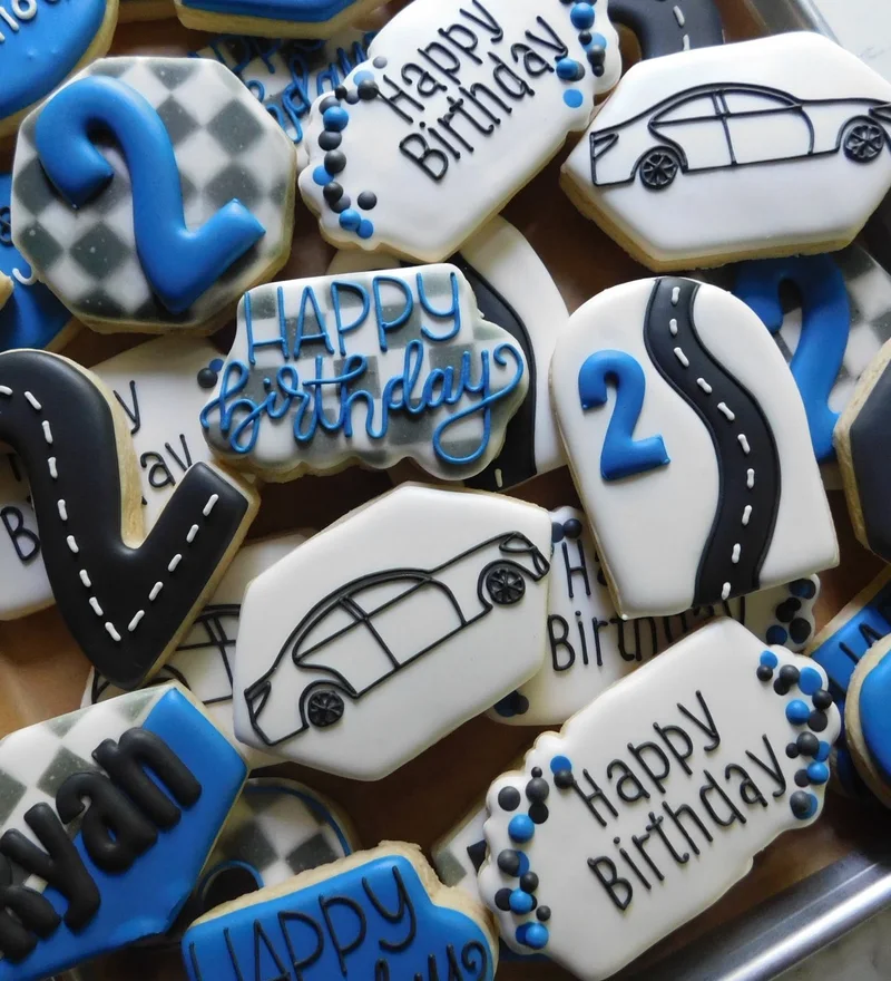 Race car and checkered-flag cookies iced for a birthday.