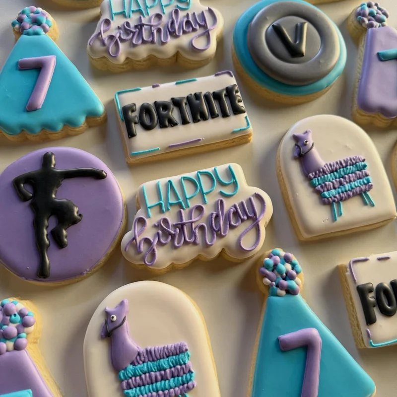 Video-game themed cookies with a happy birthday banner and the number seven.