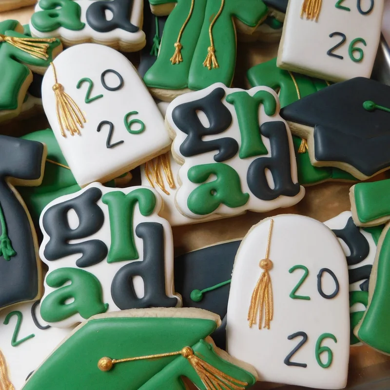 Graduation cap, diploma, and class of 2026 cookies.