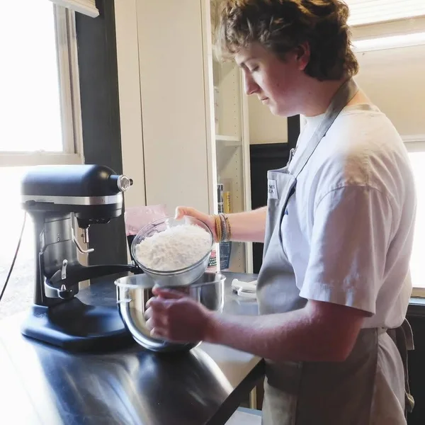 Luke mixing royal icing at the stand mixer.